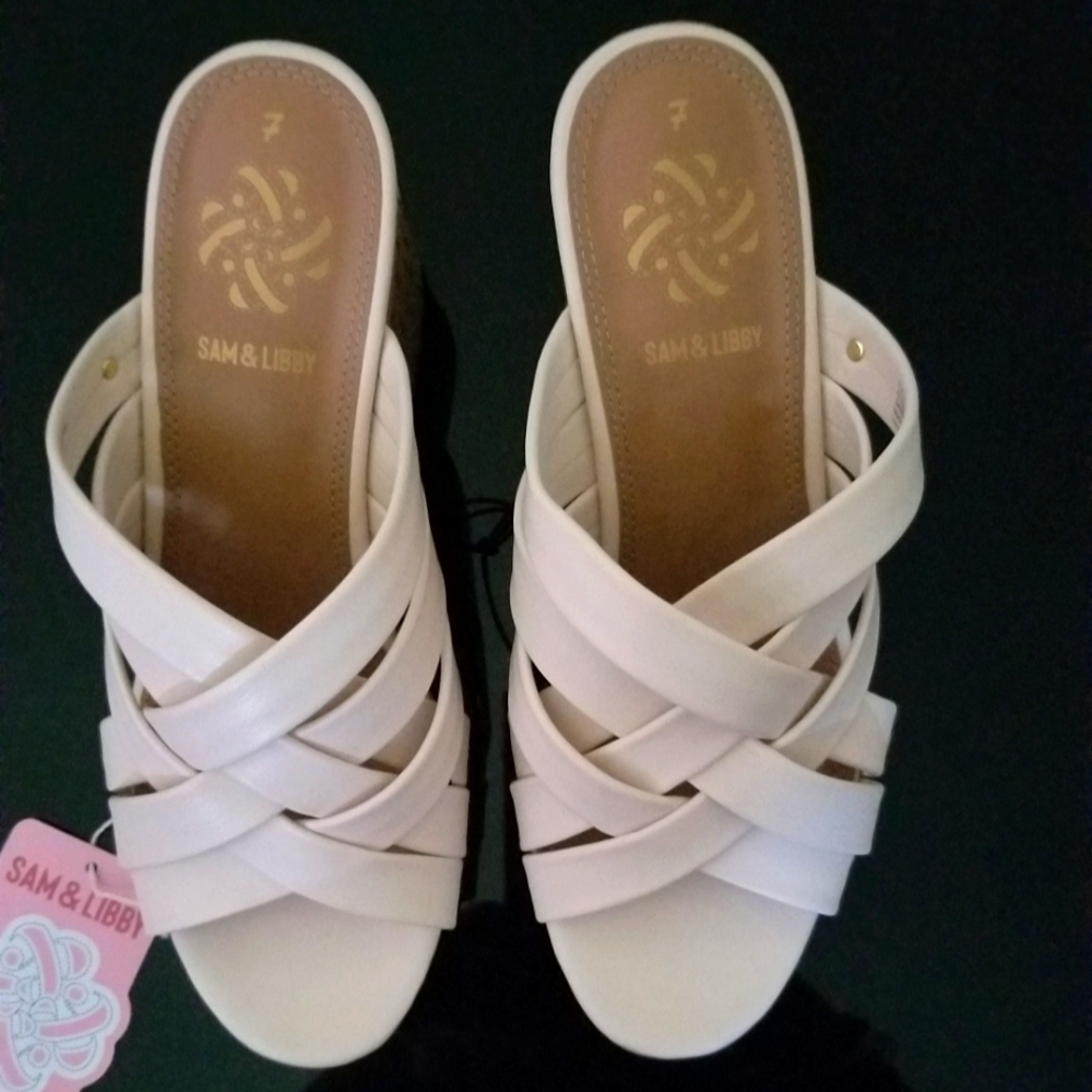 Sam & Linnt wedged heeled vanilla colored sandals.